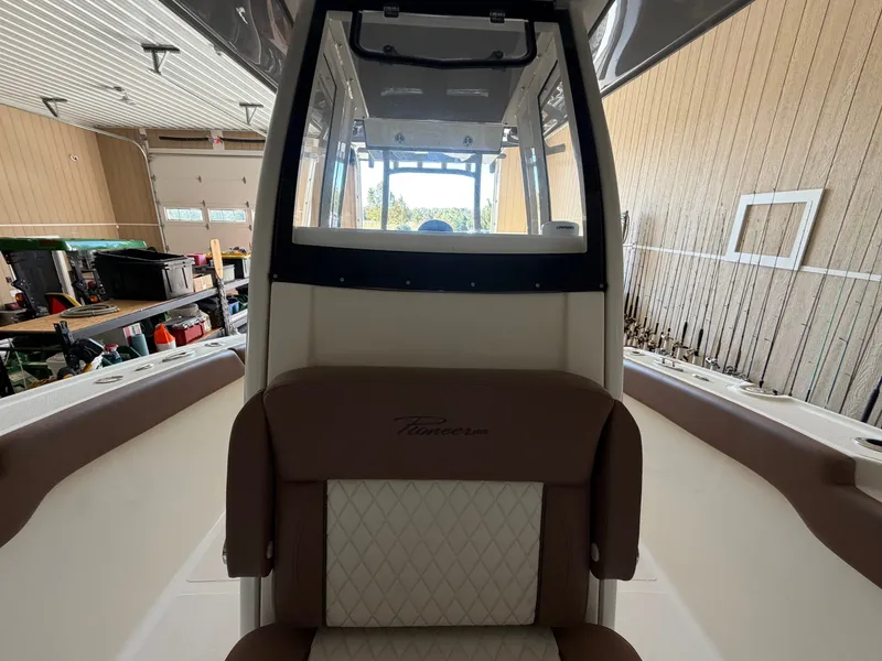 Slide: The Image of Interior view of a 2022 Pioneer 270 Pelagic with brown and white seating. - 13