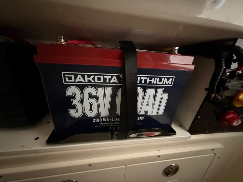 Slide: The Image of Lithium battery installed in a boat, secured with a strap. - 16