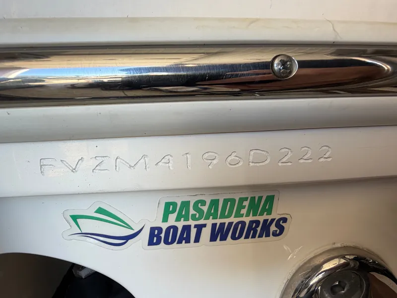 Slide: The Image of Close-up of a boat with a serial number and a Pasadena Boat Works sticker. - 36
