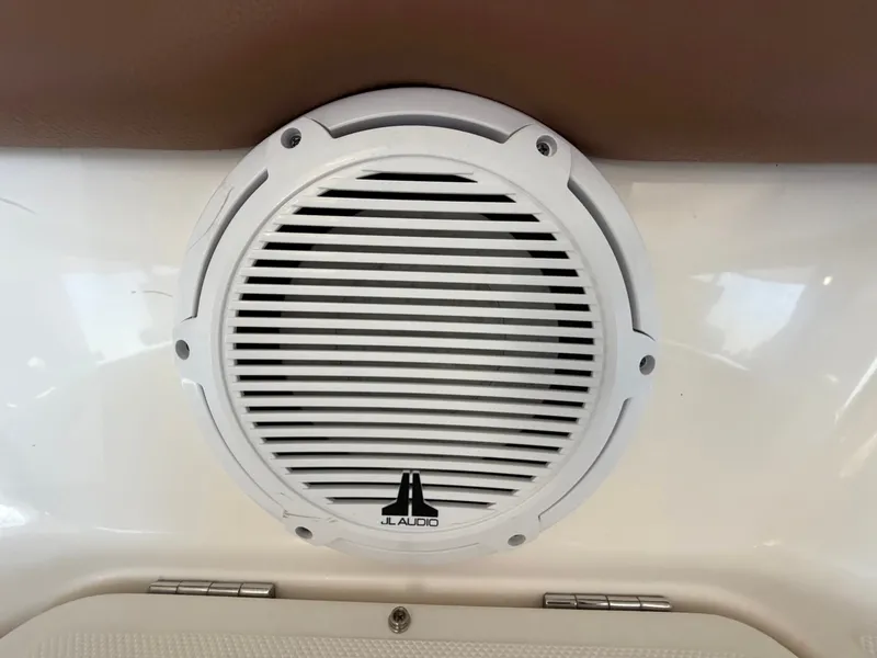 Slide: The Image of A JL Audio speaker is mounted on the white interior wall of a boat. - 22