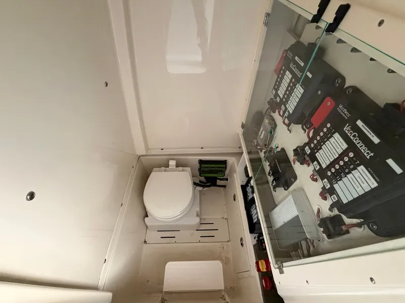 Slide: The Image of Interior view of a boat bathroom with a toilet and electrical panels. - 14