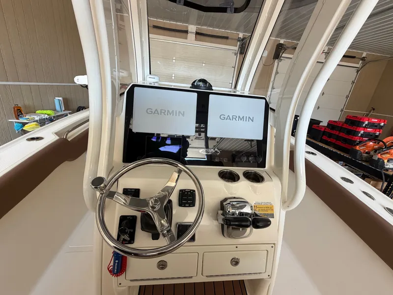 Slide: The Image of The image shows the helm of a 2022 Pioneer 270 Pelagic boat with Garmin screens. - 25