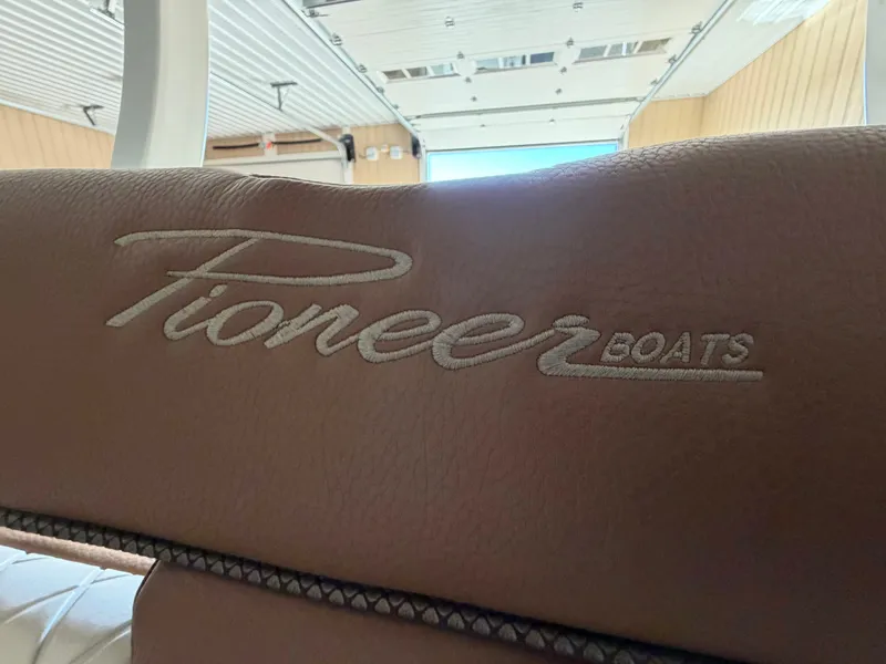 Slide: The Image of Close-up of leather seat with Pioneer Boats logo in a warehouse. - 24