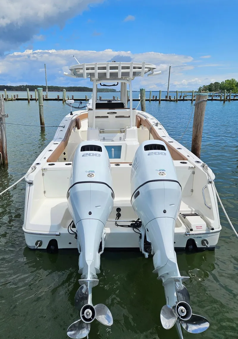 Slide: The Image of The image shows a 2022 Pioneer 270 Pelagic boat with twin outboard engines docked at a pier. - 40