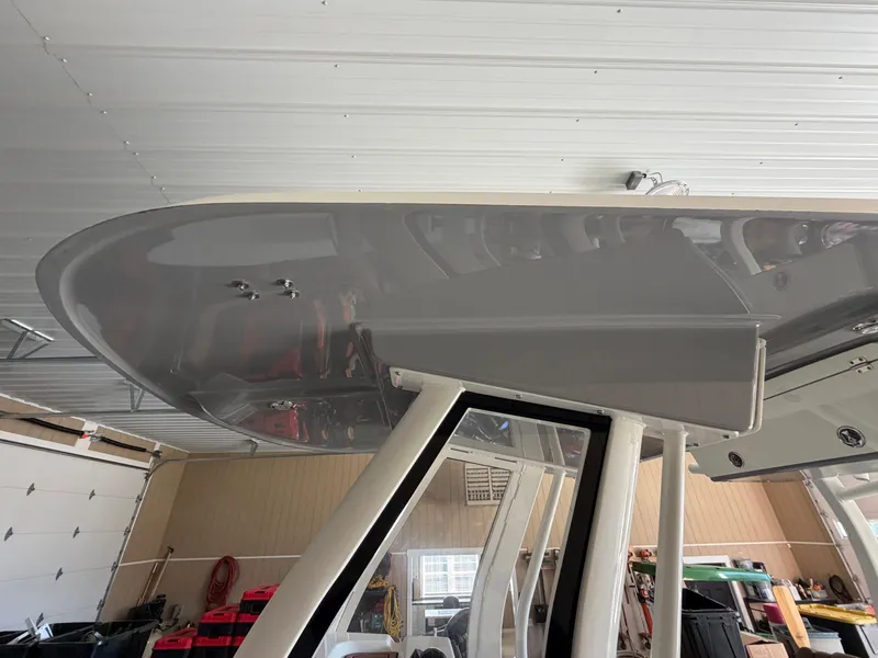 Slide: The Image of The image shows the roof of a 2022 Pioneer 270 Pelagic boat in a garage. - 19