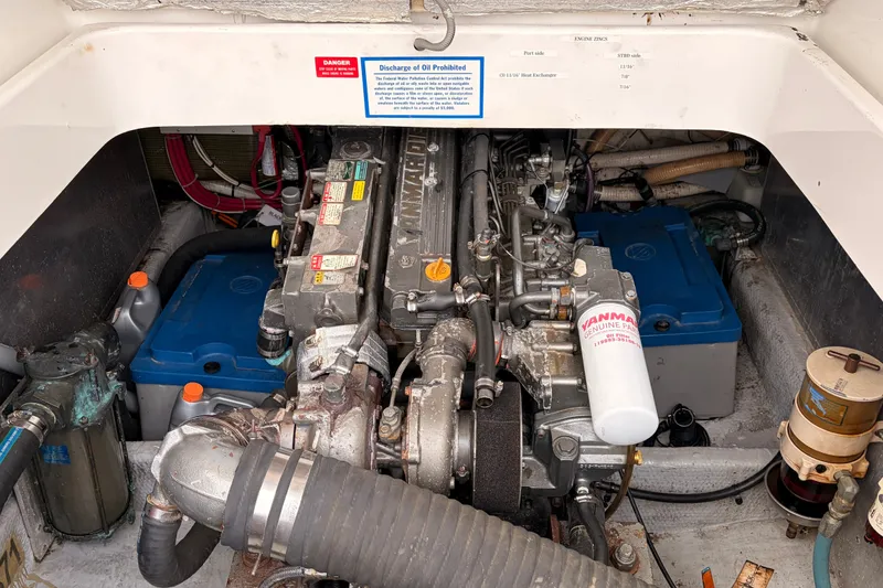 Slide: The Image of Engine compartment of a 2001 Mainship Pilot 34 with Yanmar components and blue battery boxes. - 40