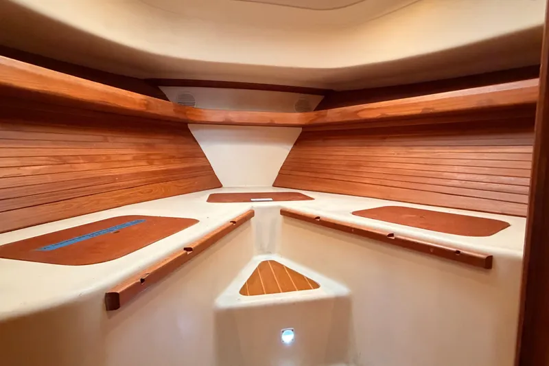 Slide: The Image of Interior cabin of 2001 Mainship Pilot 34 with wooden accents and seating area. - 38