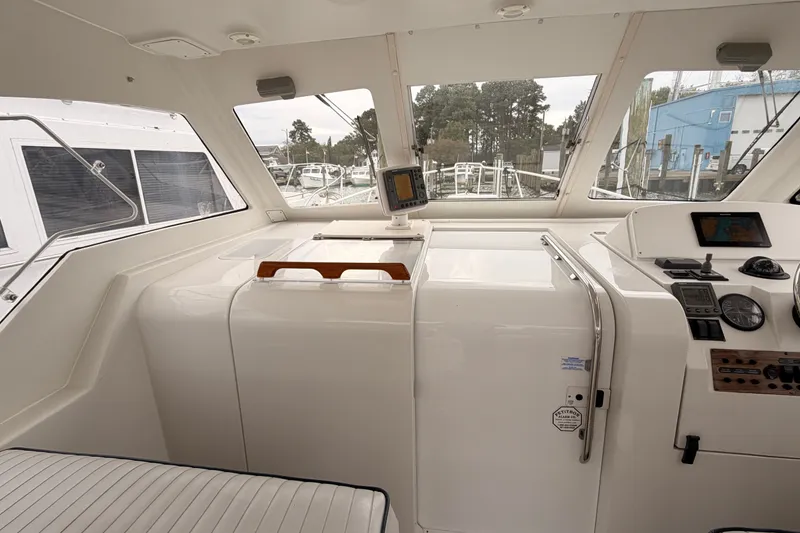 Slide: The Image of 2001 Mainship Pilot 34 boat interior with navigation equipment and seating. - 22