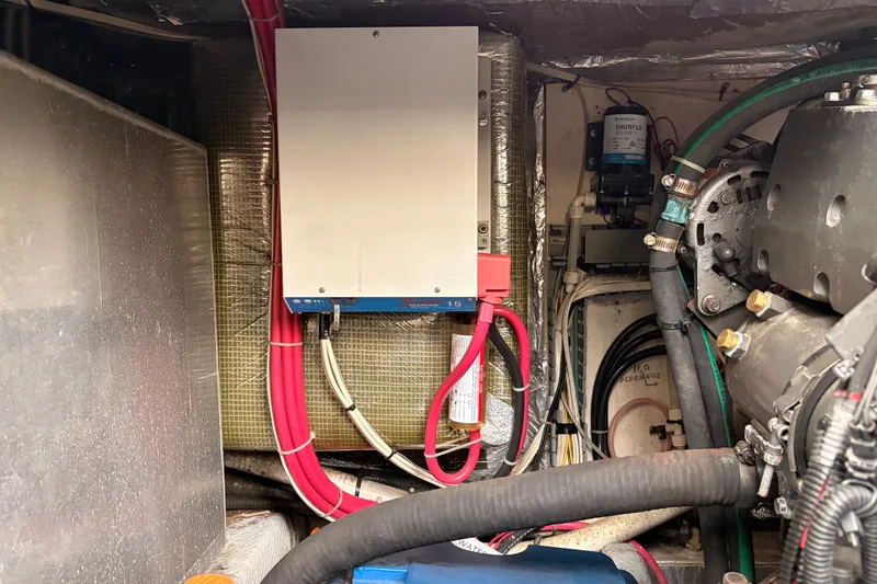 Slide: The Image of Engine compartment of a 2001 Mainship Pilot 34 with electrical components and wiring. - 43