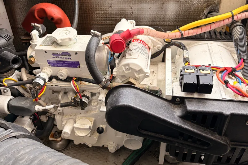 Slide: The Image of Engine compartment of a 2001 Mainship Pilot 34 boat, featuring wiring and components. - 42