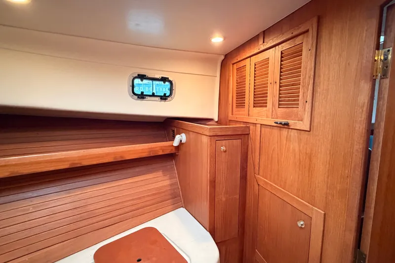 Slide: The Image of Interior of 2001 Mainship Pilot 34 boat with wooden cabinetry and porthole. - 39