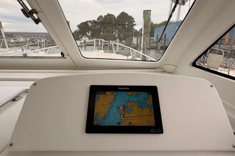 Slide: The Image of Mainship Pilot 34 (2001) helm with navigation display, docked at marina. - 16