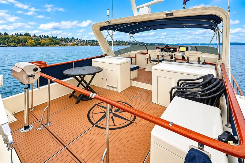 Slide: The Image of 1991 Tollycraft 61 Pilothouse Motor Yacht deck with seating and scenic water view. - 49