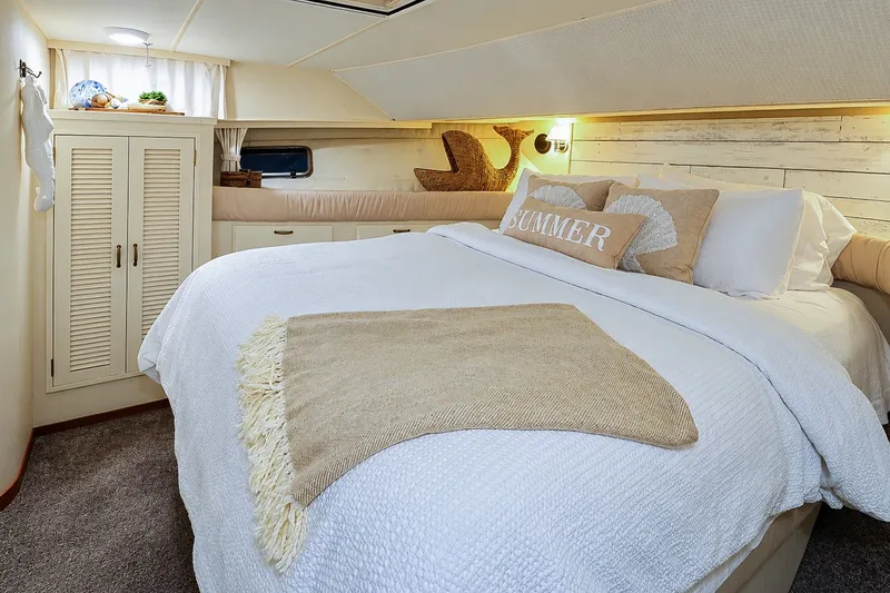 Slide: The Image of Cozy bedroom in 1991 Tollycraft 61 Pilothouse Motor Yacht with nautical decor. - 36
