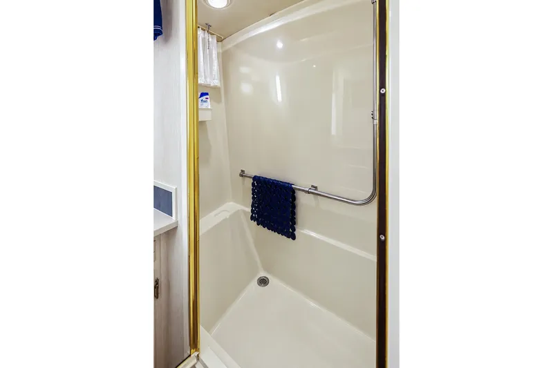 Slide: The Image of Shower area in 1991 Tollycraft 61 Pilothouse Motor Yacht with towel and toiletries. - 42