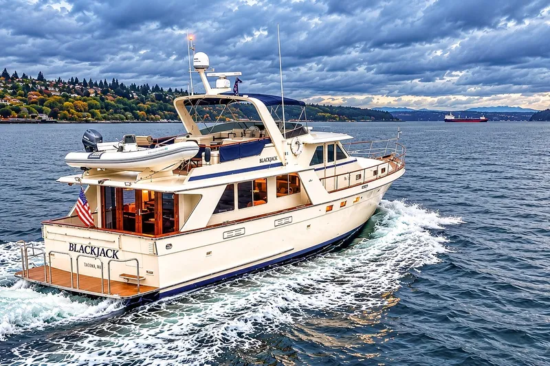 Slide: The Image of 1991 Tollycraft 61 Pilothouse Motor Yacht cruising on scenic waterway under cloudy sky. - 63