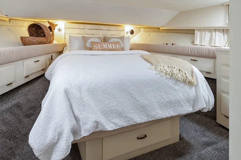 Slide: The Image of Cozy bedroom in 1991 Tollycraft 61 Pilothouse Motor Yacht with white bedding and decorative pillows. - 37