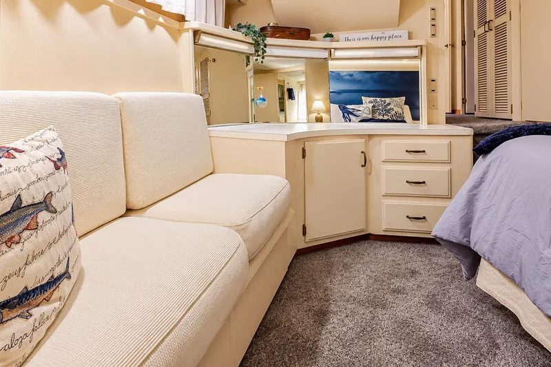 Slide: The Image of Luxurious interior of 1991 Tollycraft 61 Pilothouse Motor Yacht with cozy seating and elegant decor. - 31