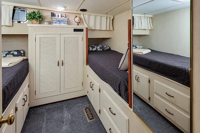 Slide: The Image of Cozy cabin interior of 1991 Tollycraft 61 Pilothouse Motor Yacht with twin beds and storage. - 43