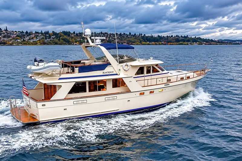 Slide: The Image of 1991 Tollycraft 61 Pilothouse Motor Yacht cruising on a scenic waterway. - 3