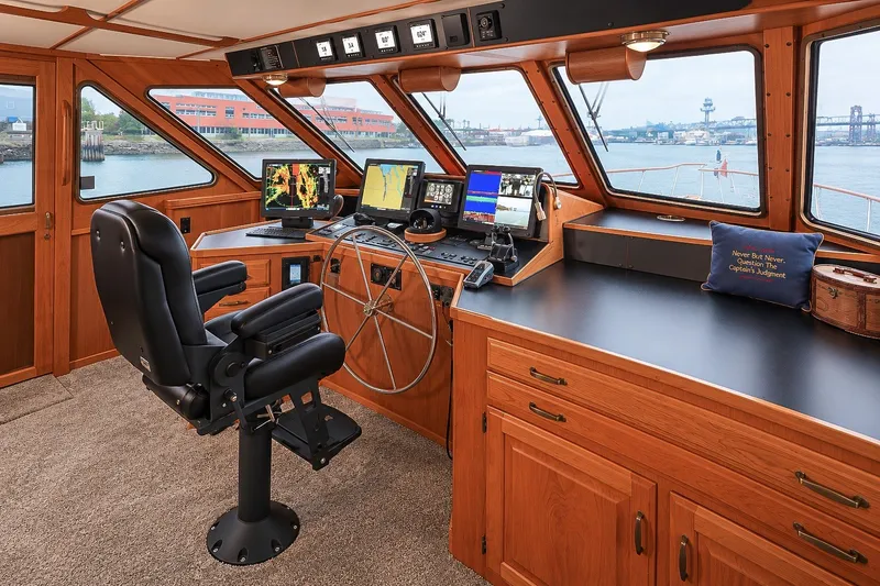 Slide: The Image of Pilothouse interior of 1991 Tollycraft 61 Motor Yacht with navigation equipment and captain's chair. - 24