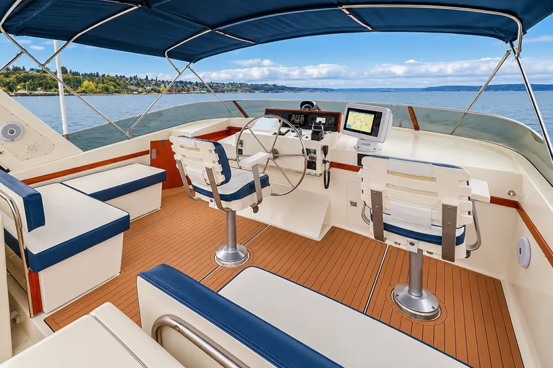 Slide: The Image of Luxurious 1991 Tollycraft 61 Pilothouse Motor Yacht interior with navigation equipment and seating. - 47