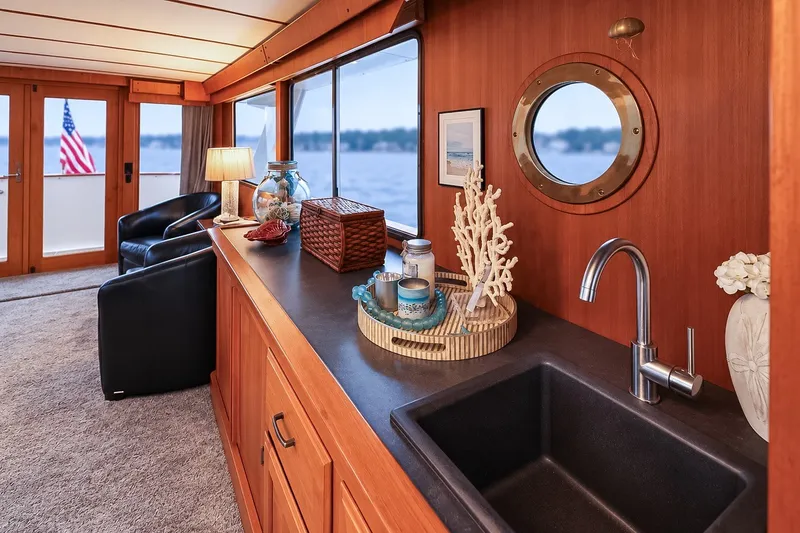 Slide: The Image of Luxurious interior of 1991 Tollycraft 61 Pilothouse Motor Yacht with elegant decor and porthole view. - 18