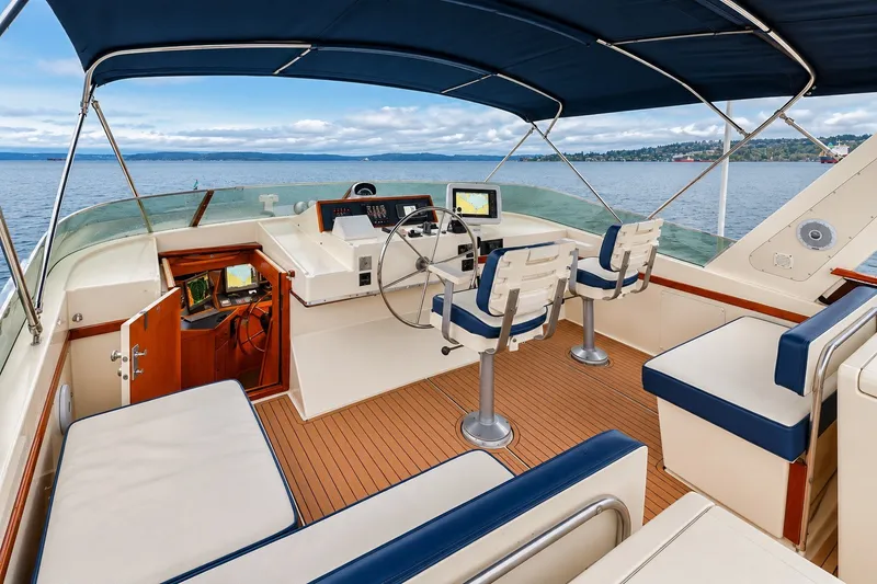Slide: The Image of 1991 Tollycraft 61 Pilothouse Motor Yacht helm with ocean view and seating. - 46