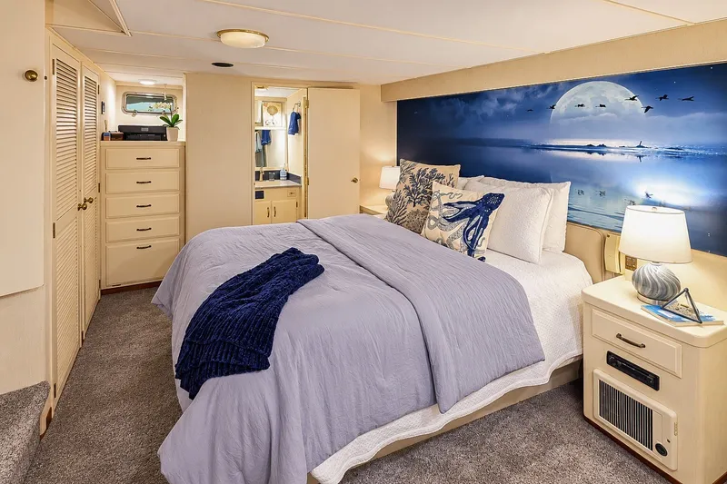 Slide: The Image of Luxurious bedroom in 1991 Tollycraft 61 Pilothouse Motor Yacht with ocean-themed decor. - 29