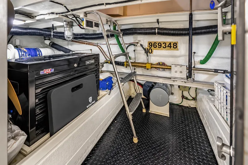 Slide: The Image of Engine room of 1991 Tollycraft 61 Pilothouse Motor Yacht with tools and equipment. - 56