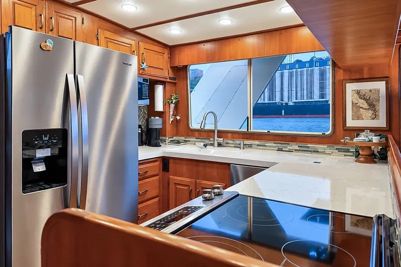 Slide: The Image of Luxurious kitchen in 1991 Tollycraft 61 Pilothouse Motor Yacht with modern appliances and waterfront view. - 21