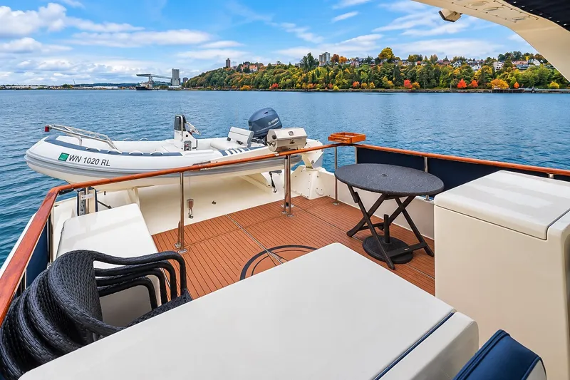 Slide: The Image of 1991 Tollycraft 61 Pilothouse Motor Yacht deck with scenic waterfront view. - 53