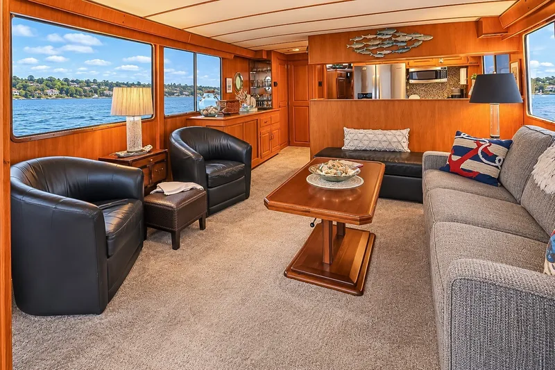 Slide: The Image of Luxurious 1991 Tollycraft 61 Pilothouse Motor Yacht interior with elegant seating and scenic water views. - 14