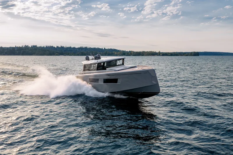 Slide: The Image of 2023 Pardo Yachts GT52 cruising on open water under a partly cloudy sky. - 5