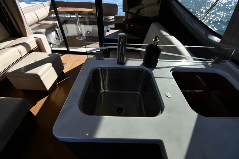 Slide: The Image of Interior of 2017 Sea Ray Sundancer 400 yacht with modern kitchen sink and seating area. - 43