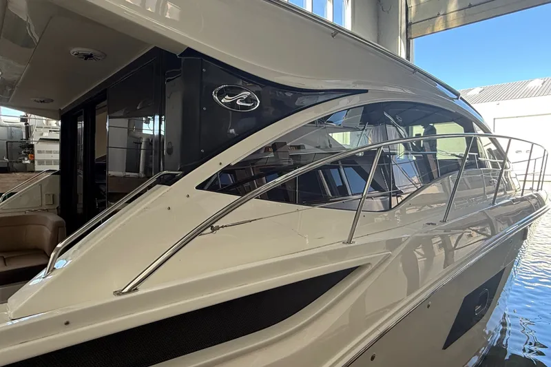 Slide: The Image of 2017 Sea Ray Sundancer 400 yacht in a marina, showcasing sleek design and modern features. - 55