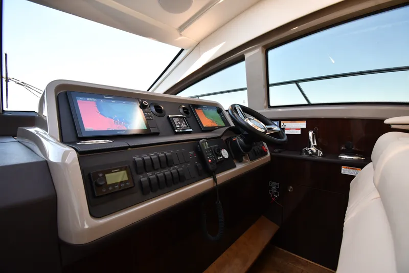 Slide: The Image of Helm of 2017 Sea Ray Sundancer 400 with navigation screens and controls. - 37