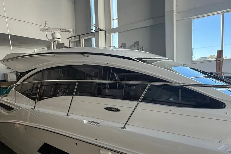 Slide: The Image of 2017 Sea Ray Sundancer 400 yacht in indoor storage, showcasing sleek design and modern features. - 54