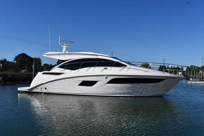 The Image of 2017 Sea Ray Sundancer 400 yacht on calm water under clear blue sky. - 0
