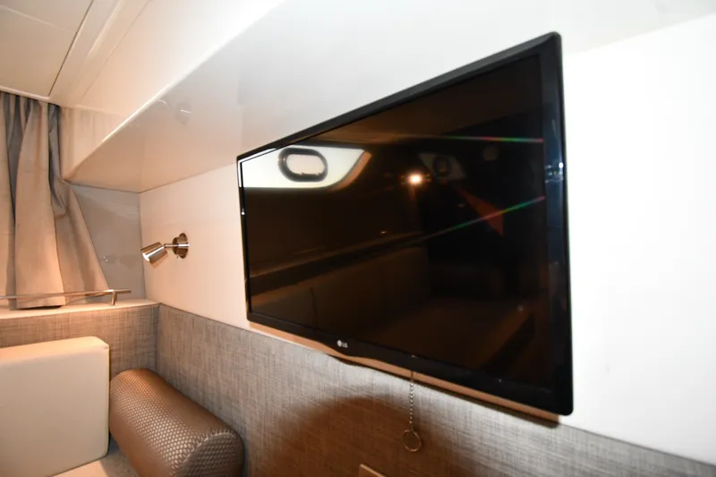 Slide: The Image of Interior of 2017 Sea Ray Sundancer 400 with mounted TV and modern decor. - 31