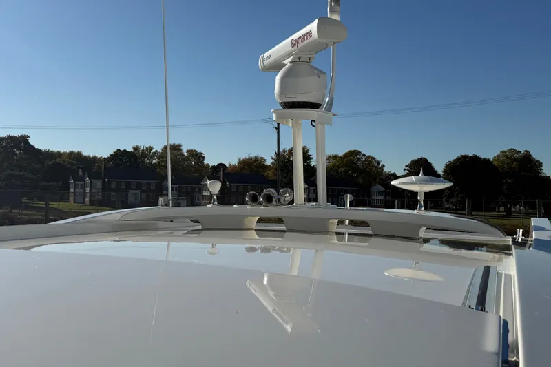 Slide: The Image of 2017 Sea Ray Sundancer 400 yacht with radar equipment, docked near residential area. - 56