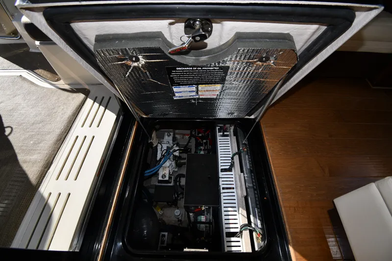 Slide: The Image of Engine compartment of a 2017 Sea Ray Sundancer 400 yacht, showcasing mechanical components. - 49