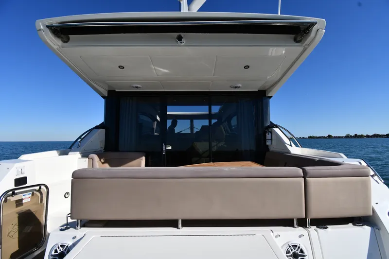 Slide: The Image of 2017 Sea Ray Sundancer 400 yacht with spacious deck and seating, cruising on open water. - 7