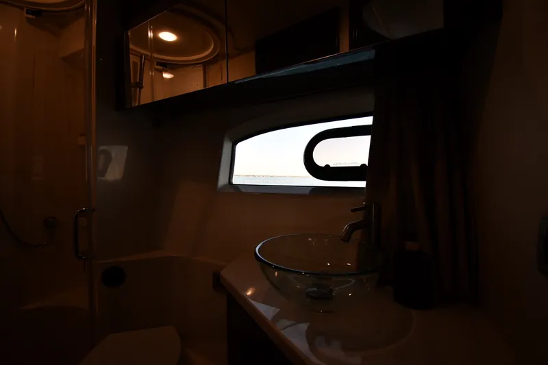 Slide: The Image of Interior of 2017 Sea Ray Sundancer 400 yacht bathroom with glass sink and porthole window. - 23
