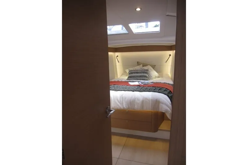 Slide: The Image of Cozy cabin interior of 2027 Jeanneau Sun Odyssey 455 yacht with skylight and bedding. - 13