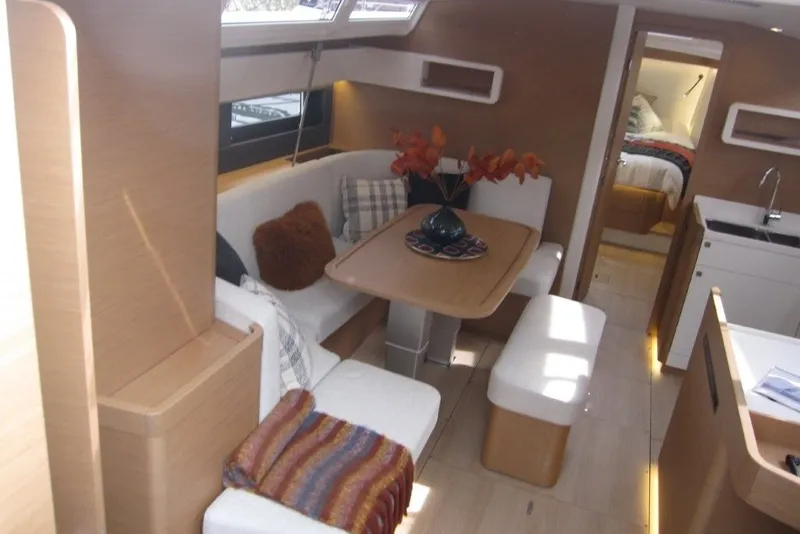 Slide: The Image of Interior of 2027 Jeanneau Sun Odyssey 455 yacht with cozy seating and modern decor. - 2