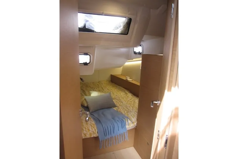 Slide: The Image of Cozy cabin interior of 2027 Jeanneau Sun Odyssey 455 yacht with bed and portholes. - 25