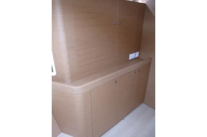 Slide: The Image of Interior cabinetry of 2027 Jeanneau Sun Odyssey 455 yacht, featuring sleek wooden design. - 20