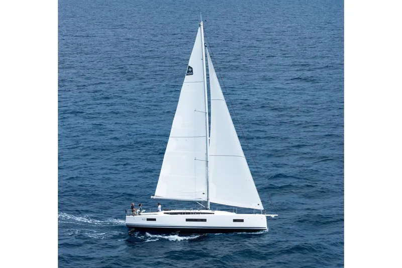 Slide: The Image of Manufacturer Provided Image: 2026 Jeanneau Sun Odyssey 455 sailing on open sea, showcasing sleek design and white sails. - 45