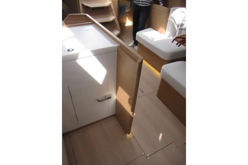 Slide: The Image of Interior of 2027 Jeanneau Sun Odyssey 455 yacht, featuring modern seating and cabinetry. - 9